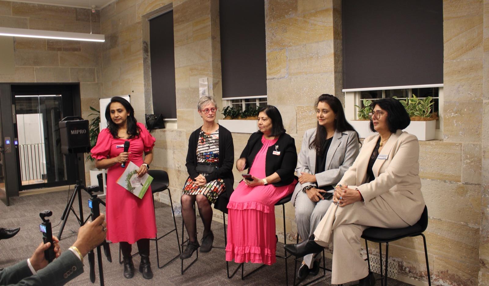 Women panellists speaking at an Artha community panel discussion.