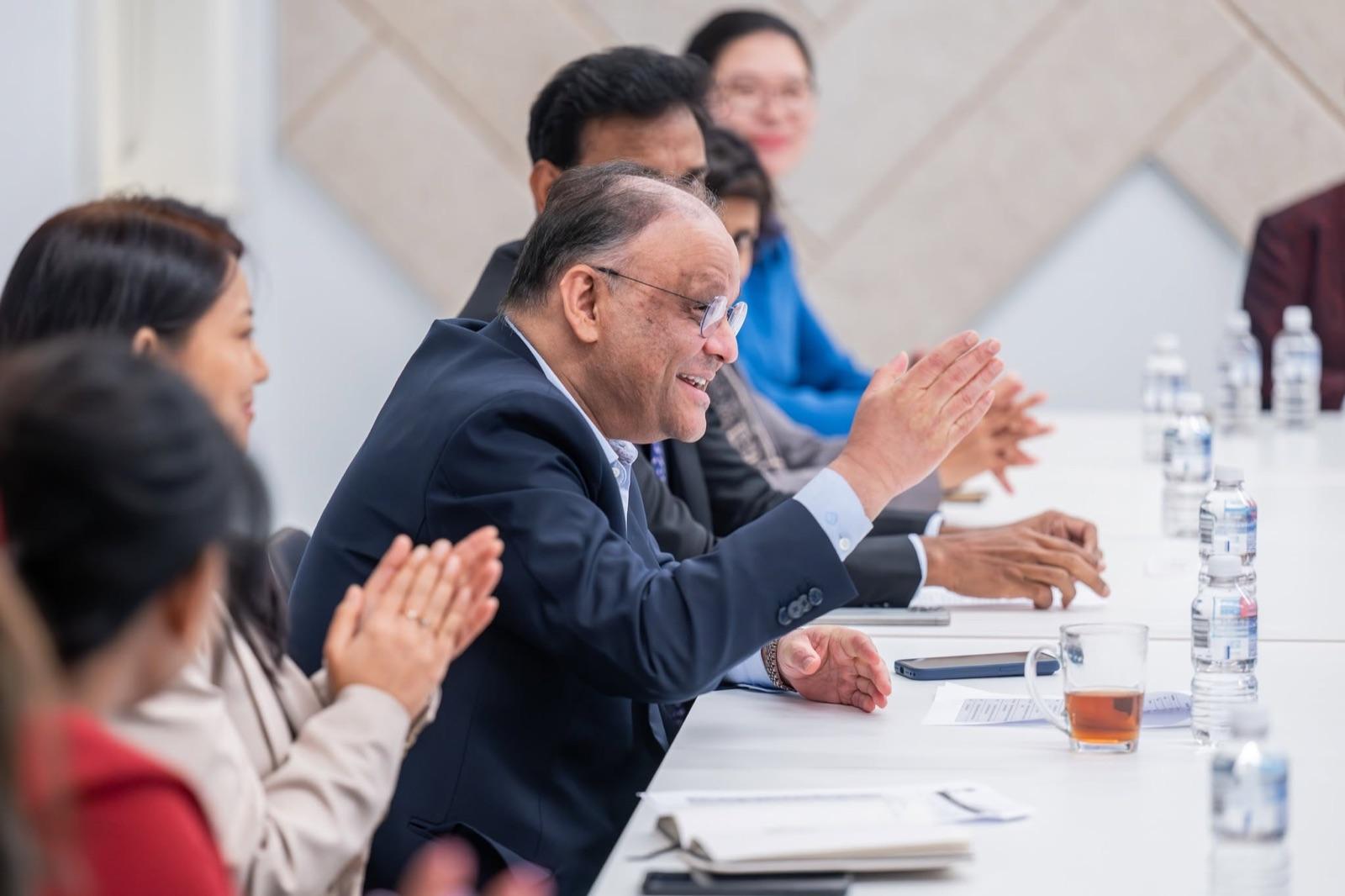 A mentor listening during a session at the Artha Business Roundtable.