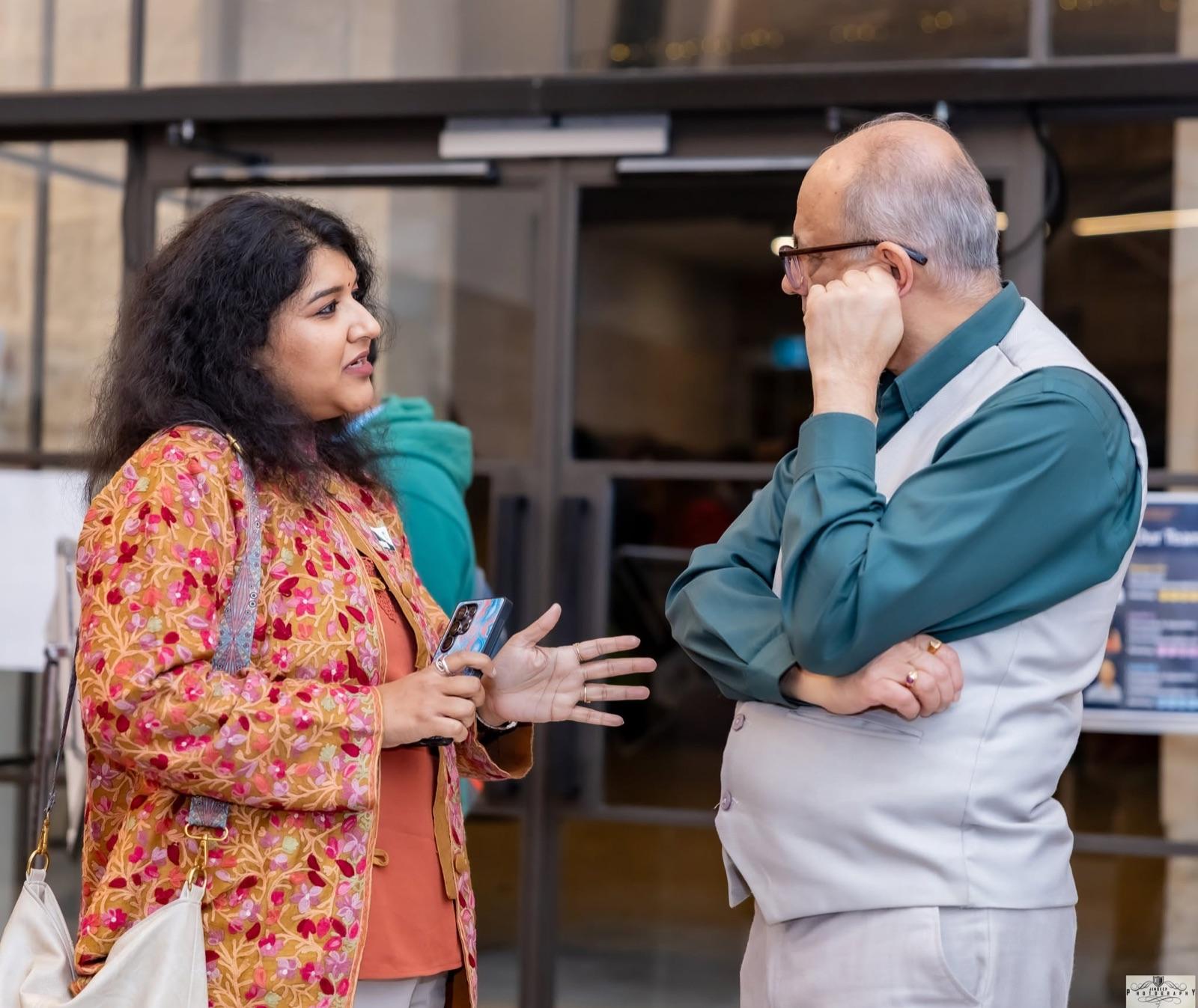 Two members in conversation at the Artha Business Roundtable.
